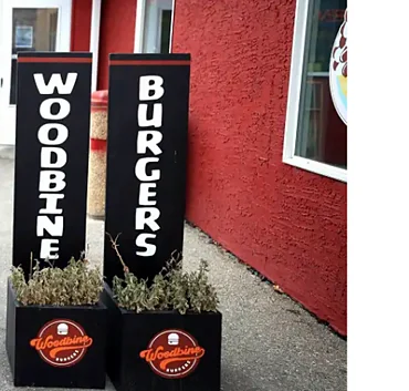 Woodbine Burgers sign banners on the patio