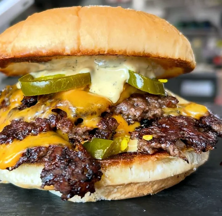 Close-up of a double cheeseburger with pickles