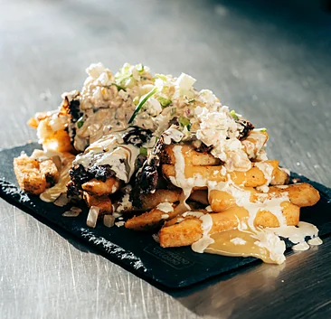 Loaded fries with cheese sauce and green onion